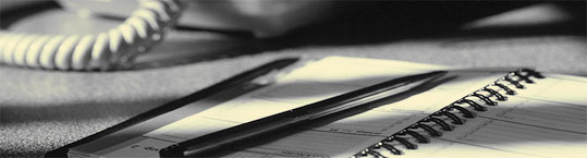 Photo of appointment book with phone partially visible in the background
