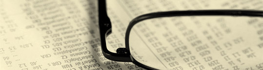 Photo of reading glasses on a newspaper